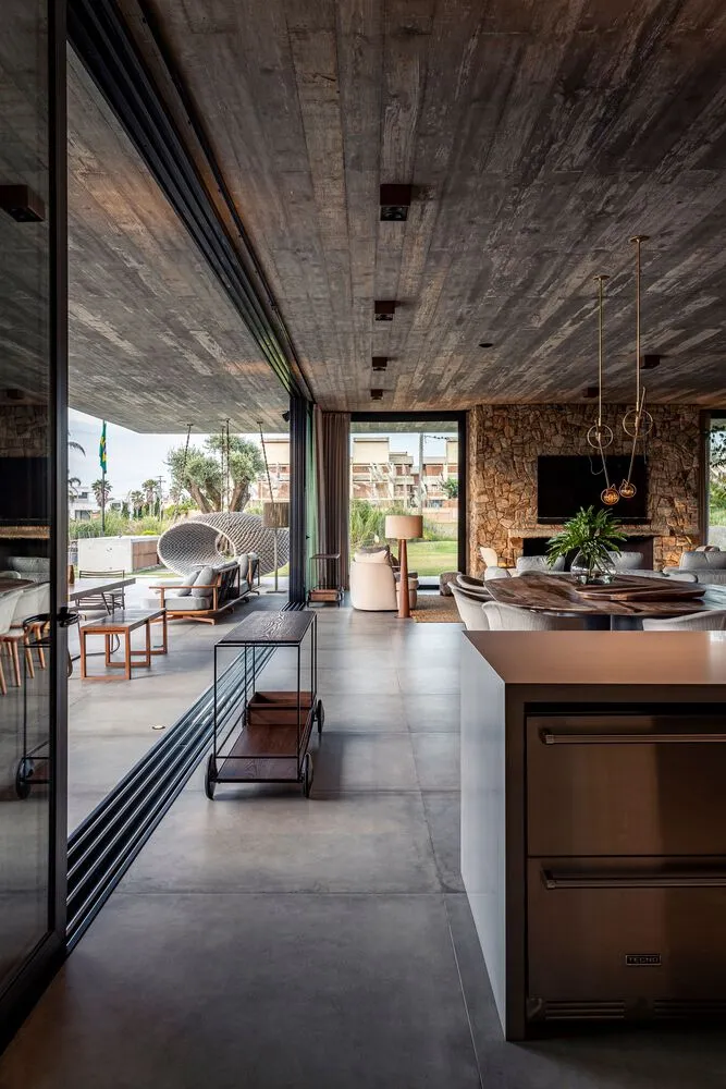 A modern residential living space featuring a concrete and stone interior design.