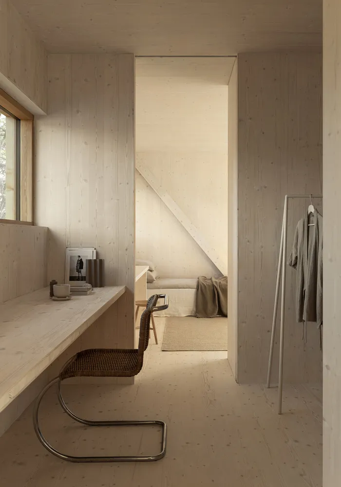 A minimalist bedroom with wooden furniture and a neutral color palette.