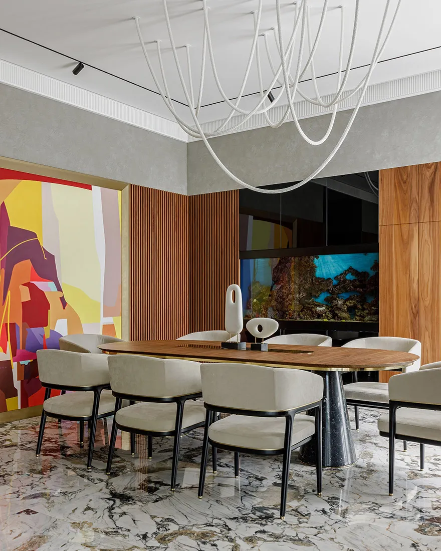 Modern dining room with a wooden table and chairs, marble floor, and abstract wall art.