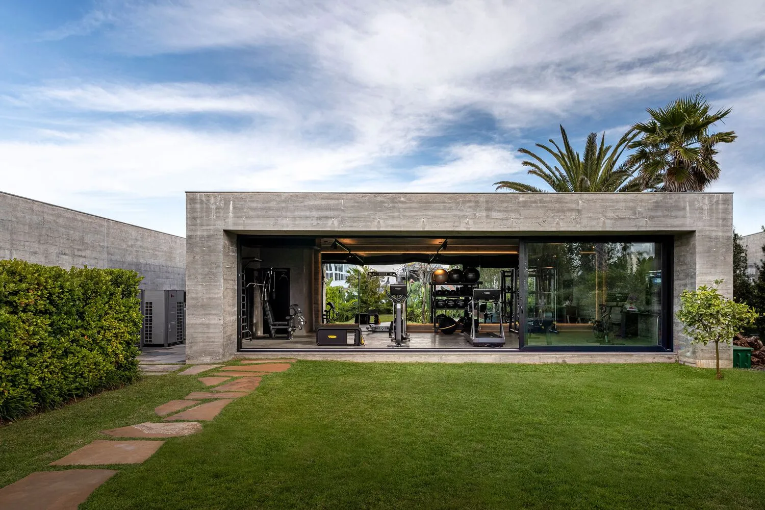 Modern outdoor gym with concrete structure and lawn