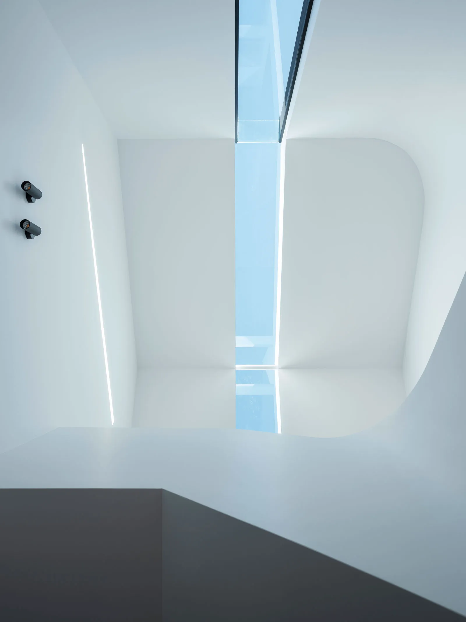 Modern interior with glass walls and ceiling.