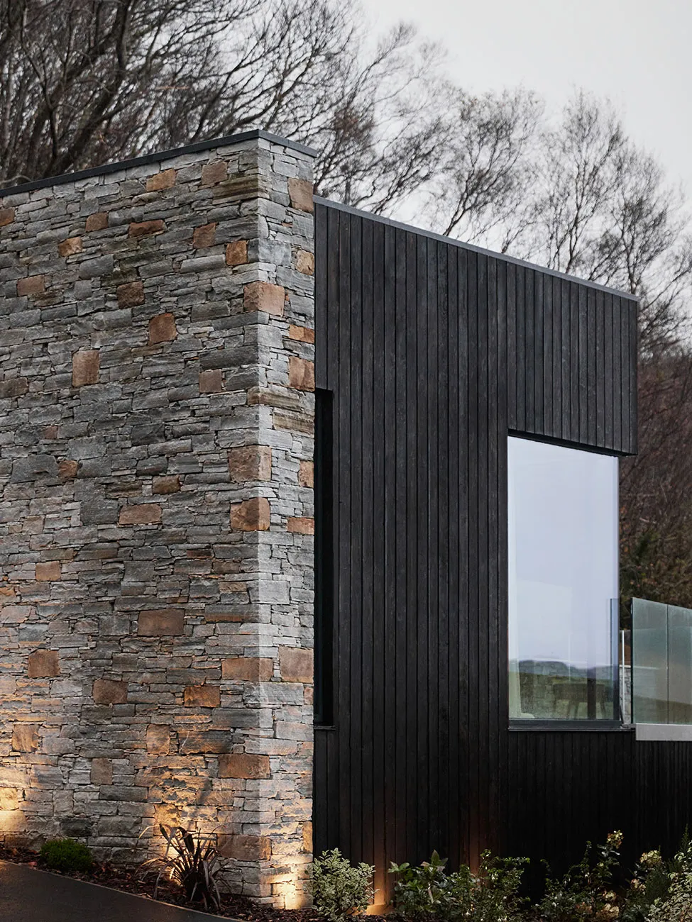 Modern building exterior featuring stone and wooden accents
