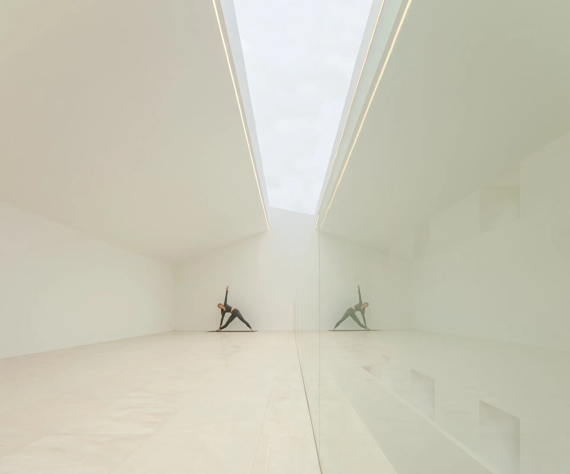 A modern interior space with a white glass ceiling and minimalist design.