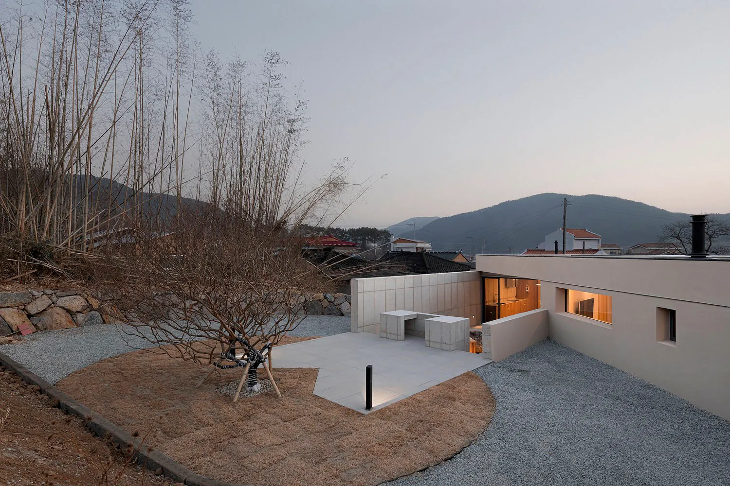 A modern residential exterior with a minimalist design featuring a concrete structure.
