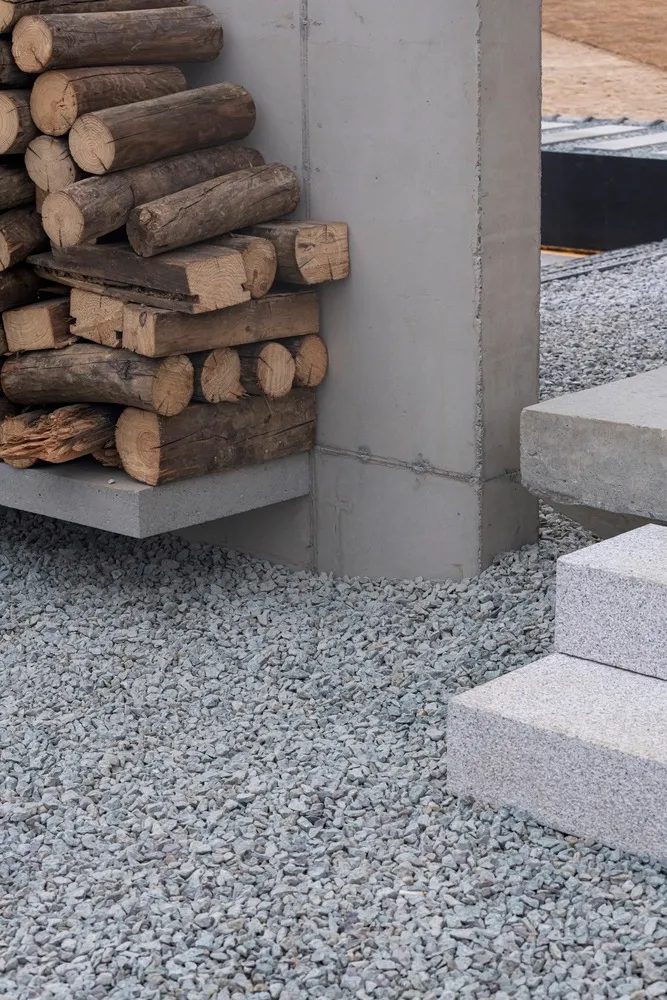 A modern industrial exterior featuring concrete columns and steps.