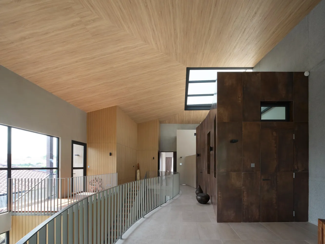 A modern interior space featuring wooden flooring and concrete walls.
