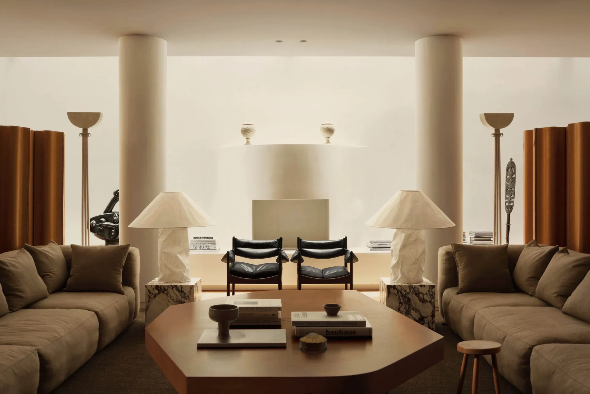 A modern living room featuring concrete, leather, and marble materials.