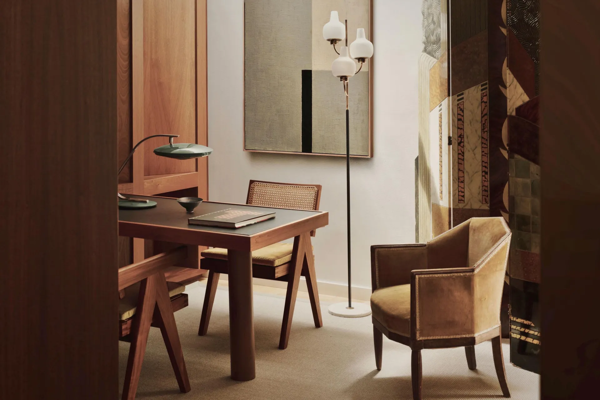 A modern dining table with a wooden finish, featuring a menu or cookbook placed on top.