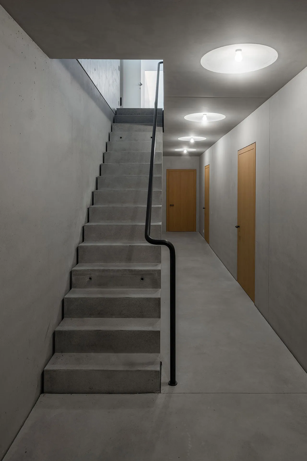 Concrete stairwell with minimalist design and dark color.
