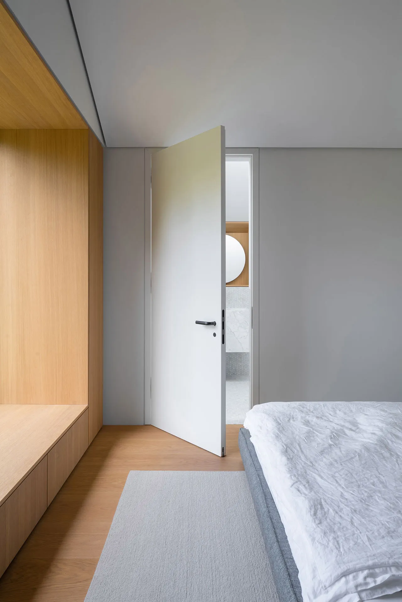 Modern minimalist bedroom featuring minimalist design elements like wood, marble, and metal.