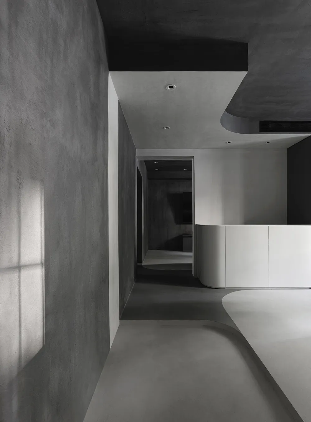 Modern office space featuring concrete flooring and walls