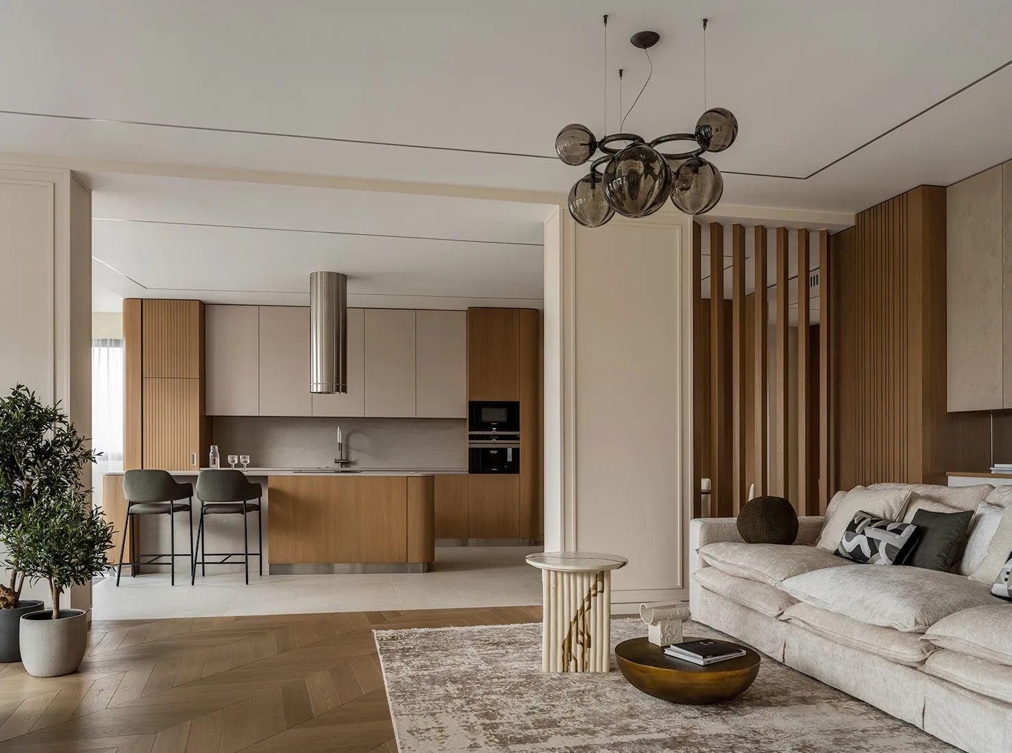 Modern minimalist living room with wooden elements, marble finishes, and metallic accents.