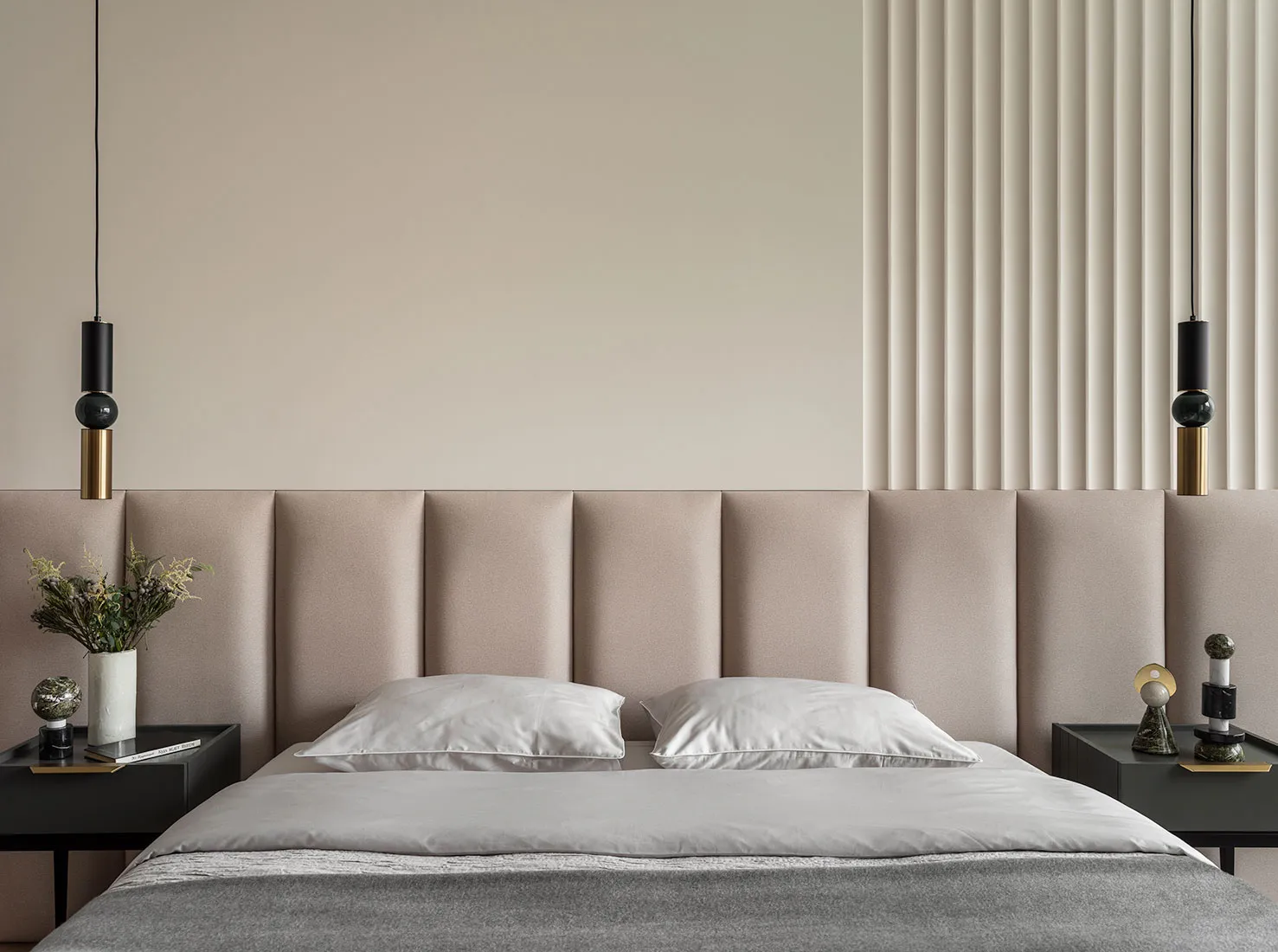 Modern bedroom with fabric headboard and pillows, featuring contemporary design elements.