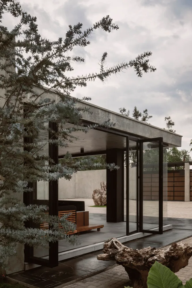 Concrete and glass minimalist residential facade under cloudy skies.