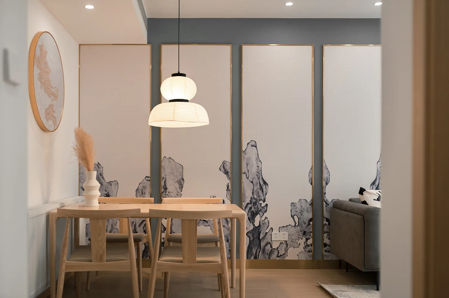 A modern dining room featuring subtle patterns on the walls, wooden furniture, and minimalist decor.