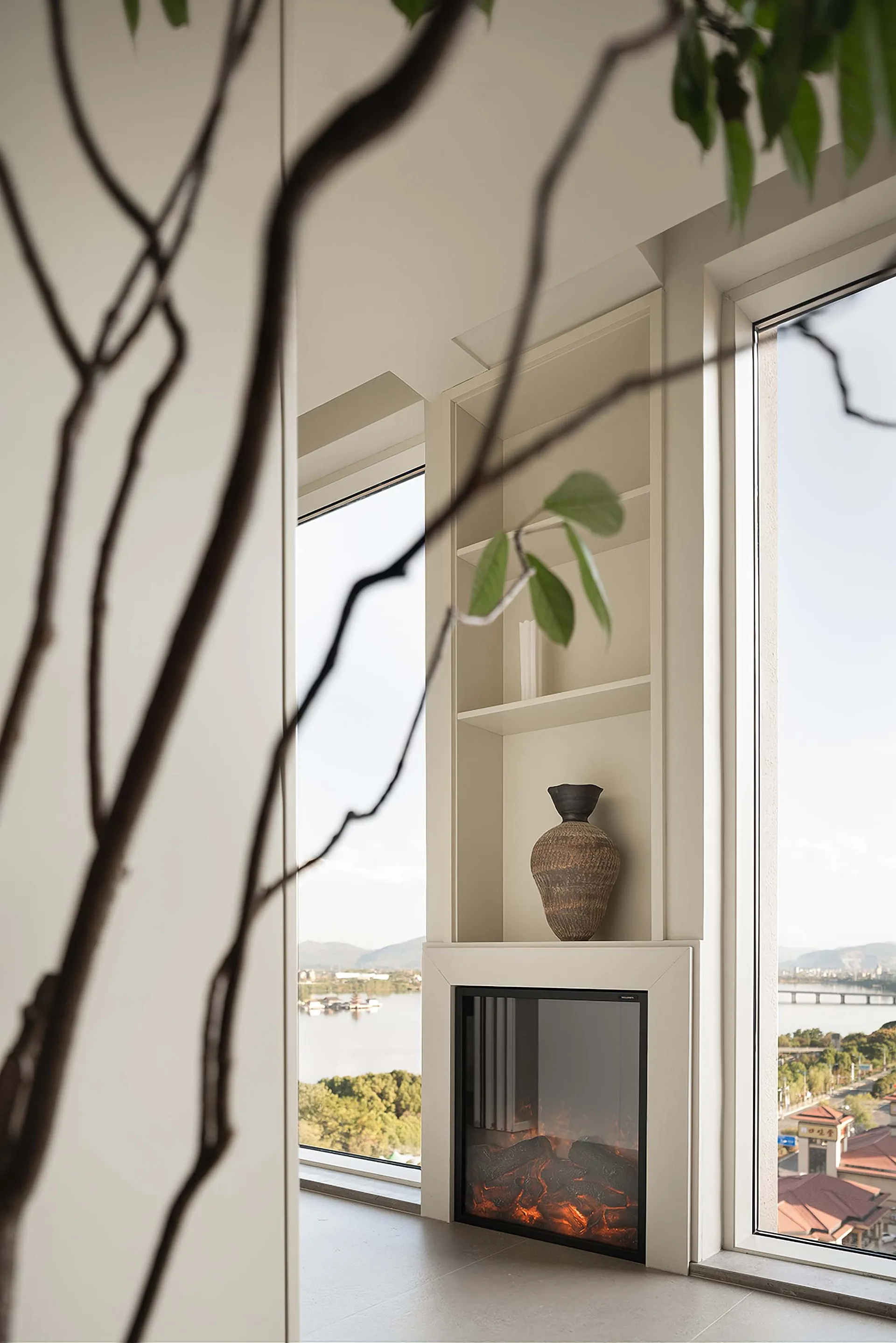 Modern ceramic vase sitting on a white console table in a living room.