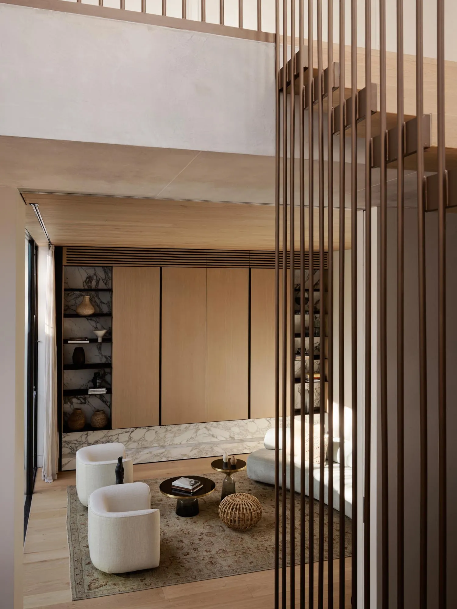 Modern living room featuring wooden furniture, marble accents, and concrete flooring.