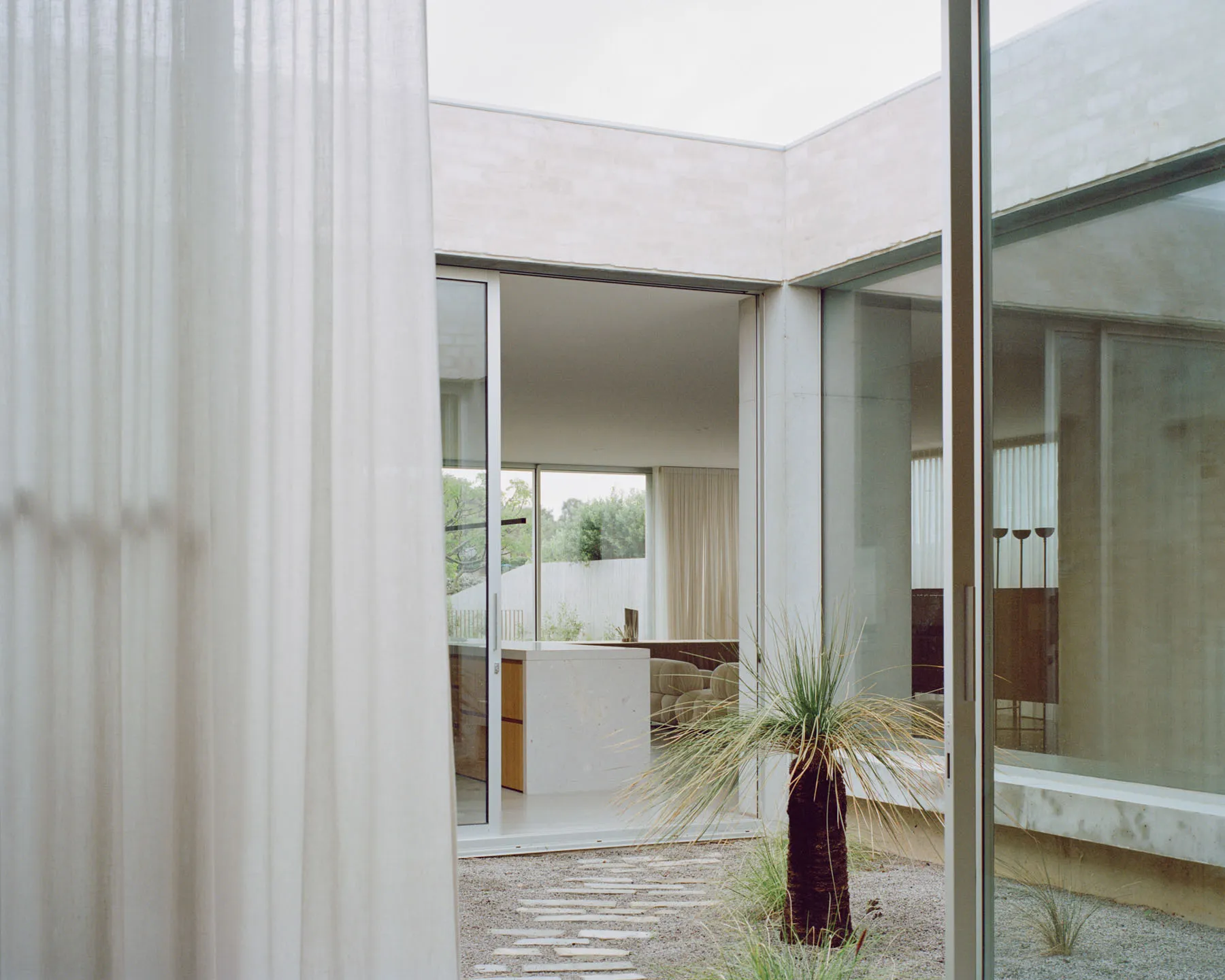 Modern interior design featuring glass and concrete materials.