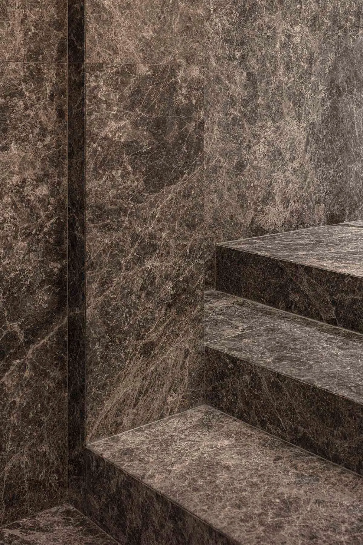 Minimalist staircase made of polished marble, showcasing contemporary design principles with an accent on natural materials.