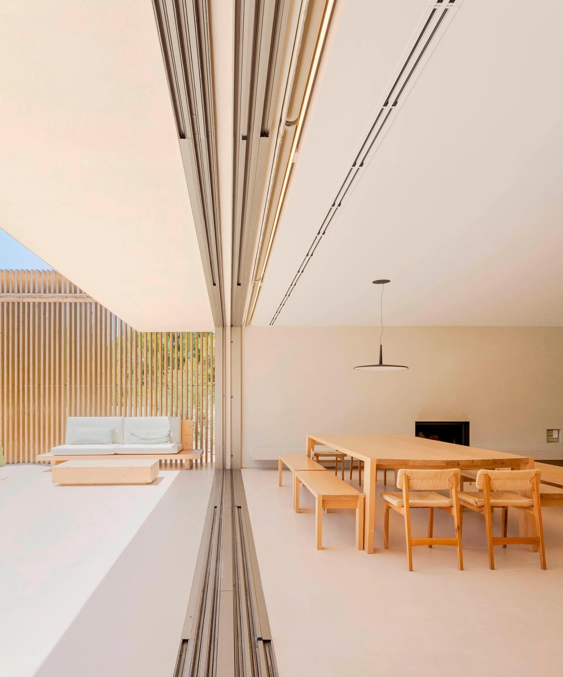 A minimalist residential interior designed with wood and white materials.