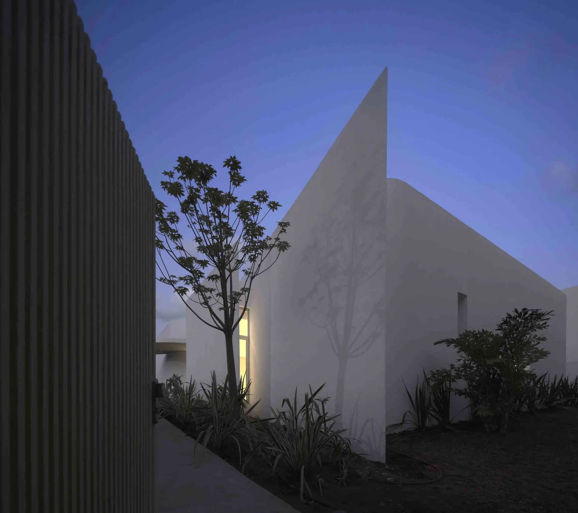 Simplified minimalist residential architecture with modern materials and geometric shapes.