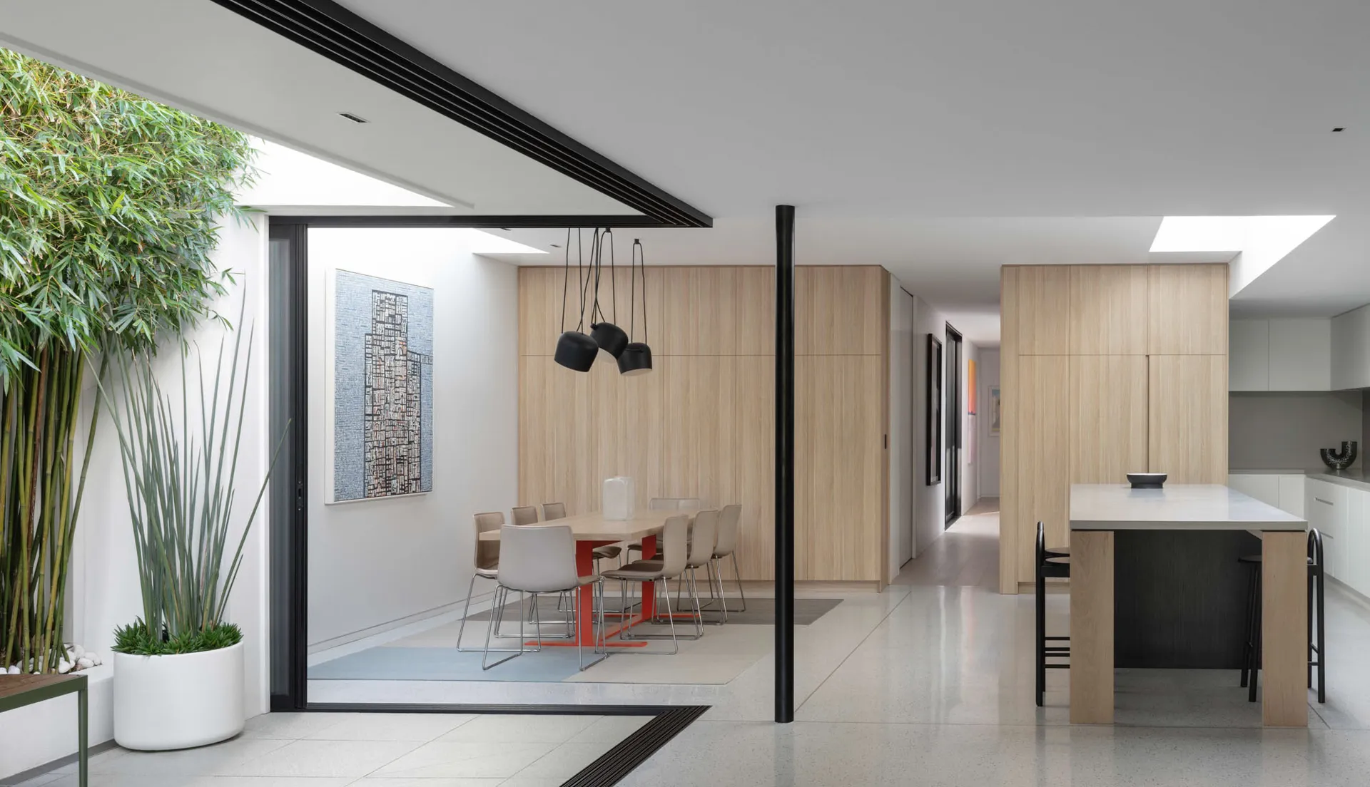 A modern residential interior featuring wood and glass materials.