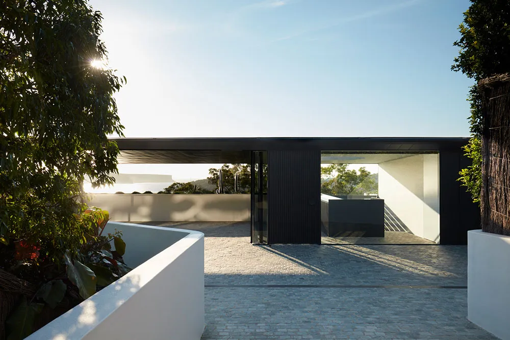 A modern house entryway featuring metal and glass materials.