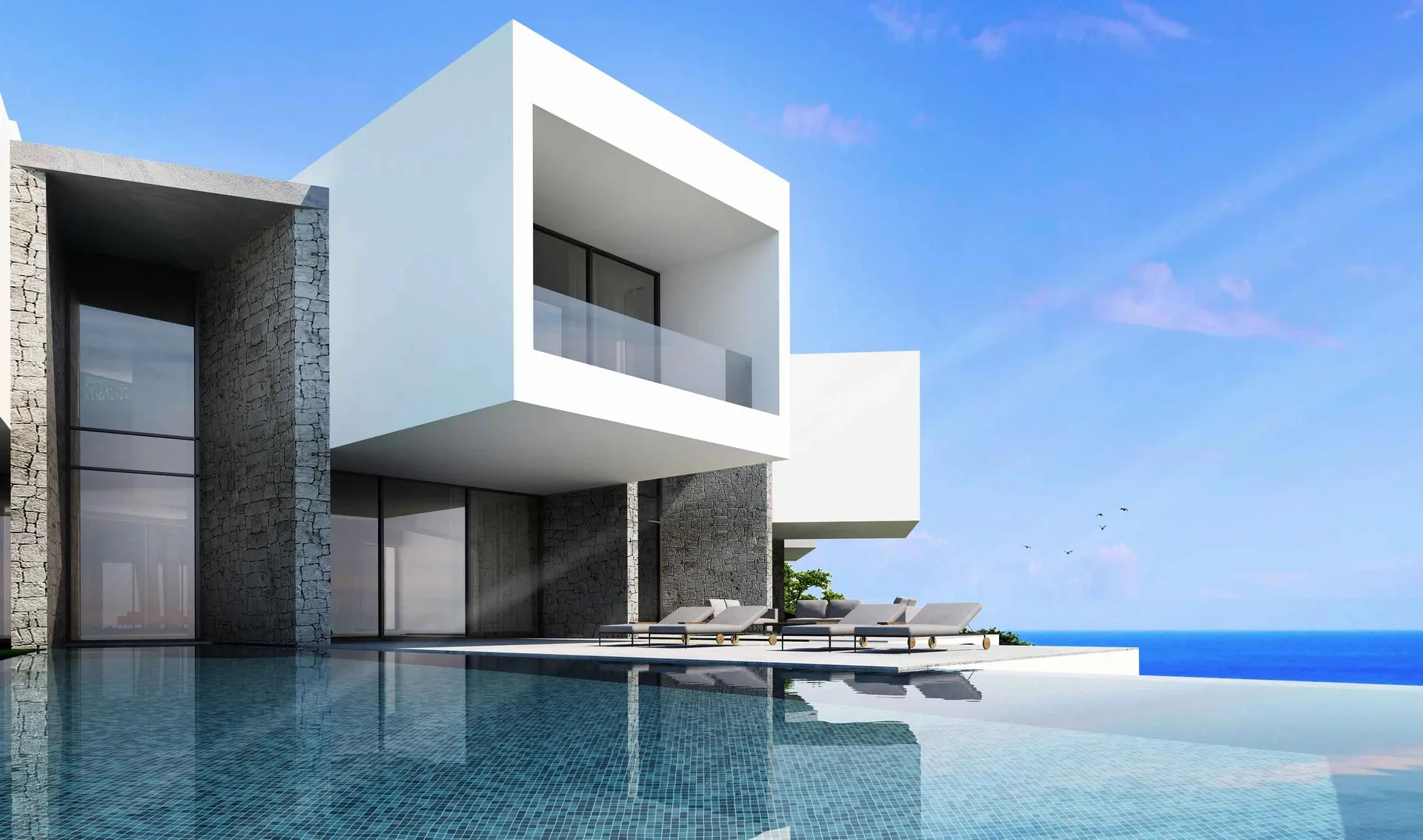 White modern house with glass windows, concrete walls, and a large infinity pool overlooking the ocean.
