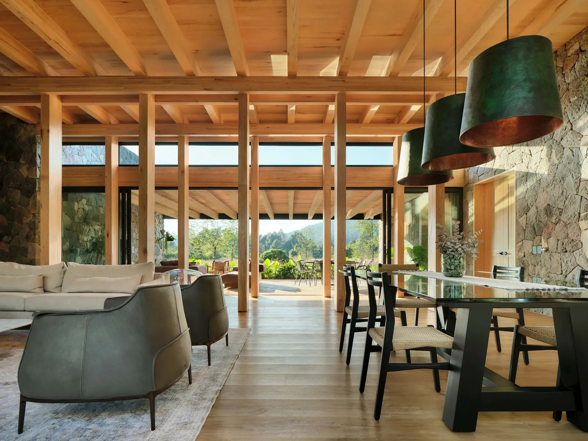 Modern interior with wooden beams, sofas, tables, and chairs.