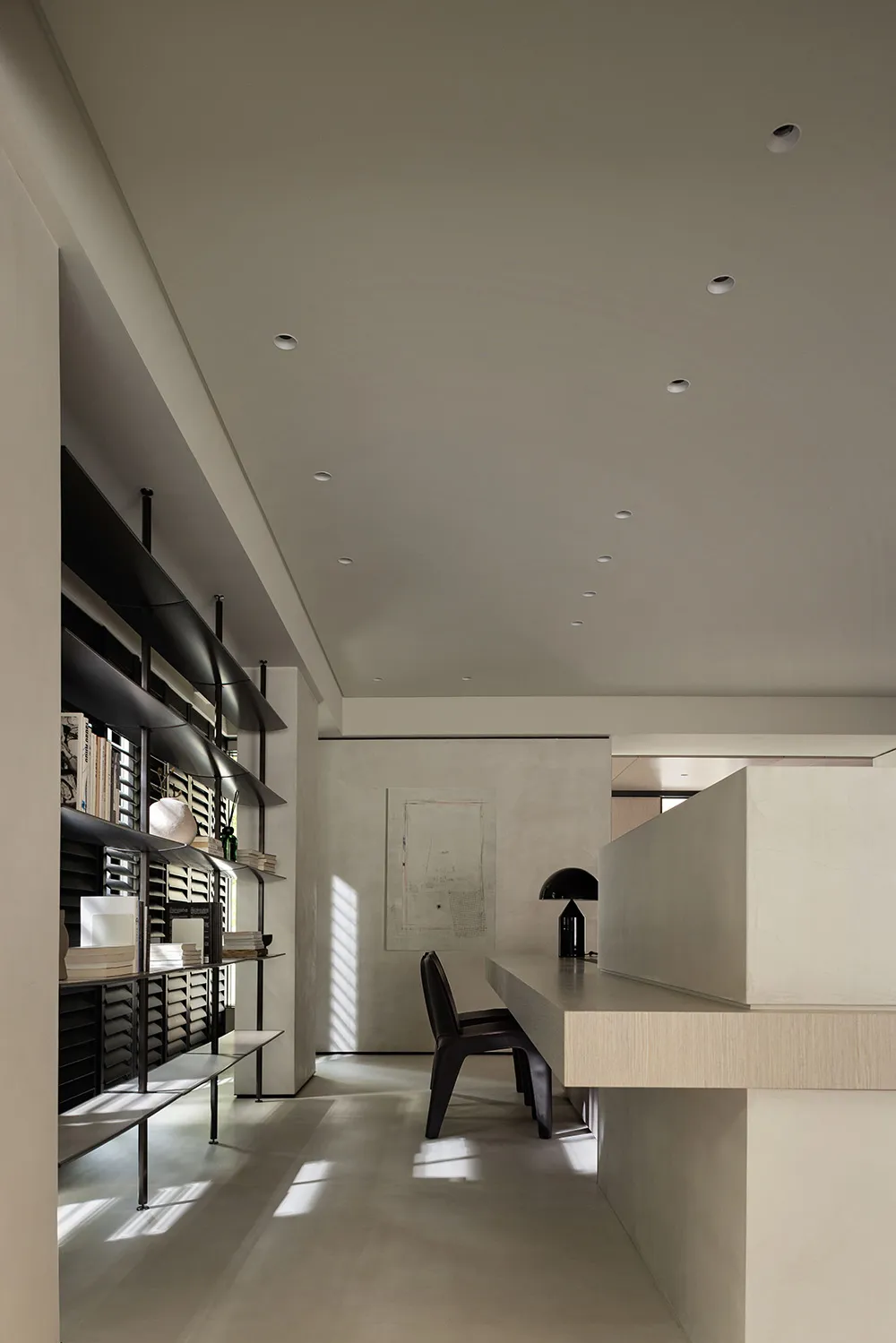A minimalist home office featuring a concrete cabinet and a sleek, contemporary workspace.