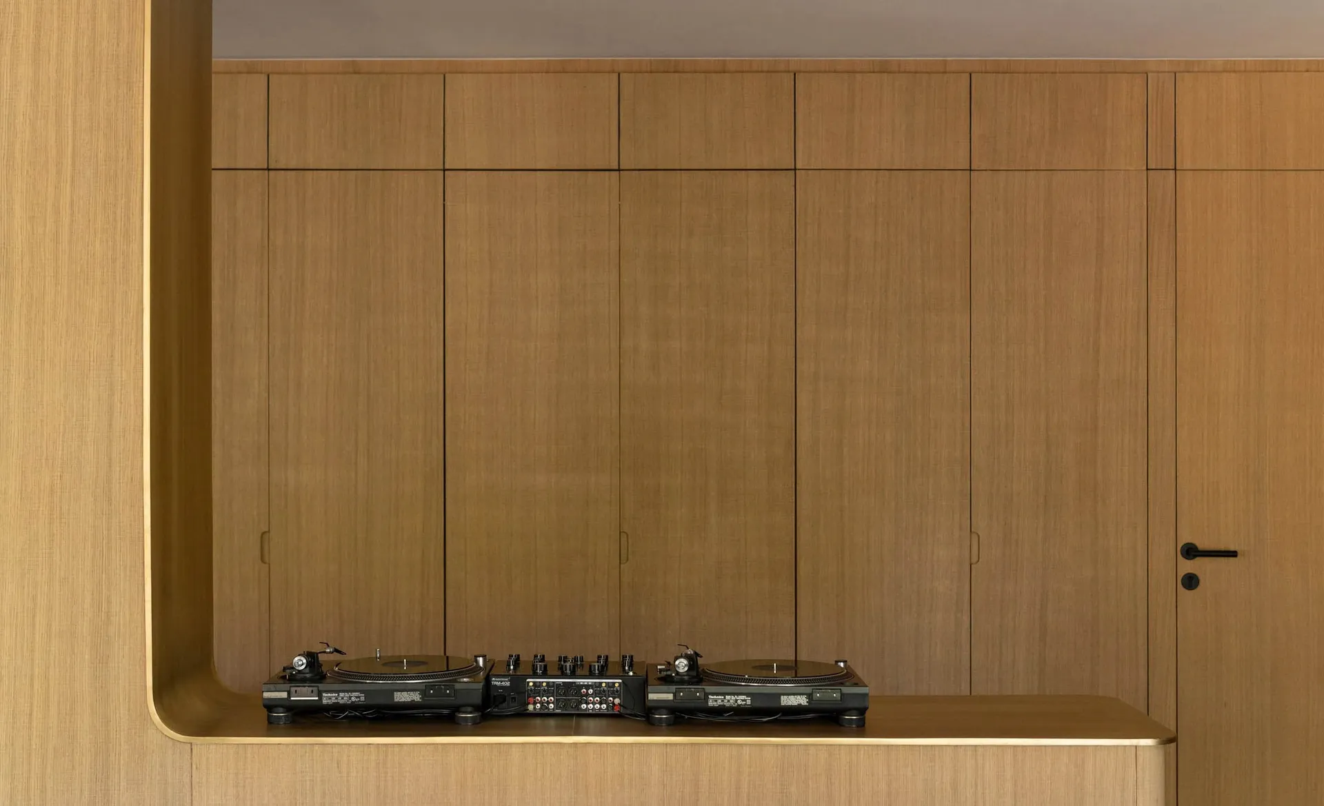 A modern home studio with wooden walls and a sleek, contemporary design.