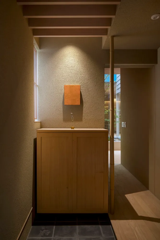 Modern industrial entryway with wooden cabinet and minimalist design.