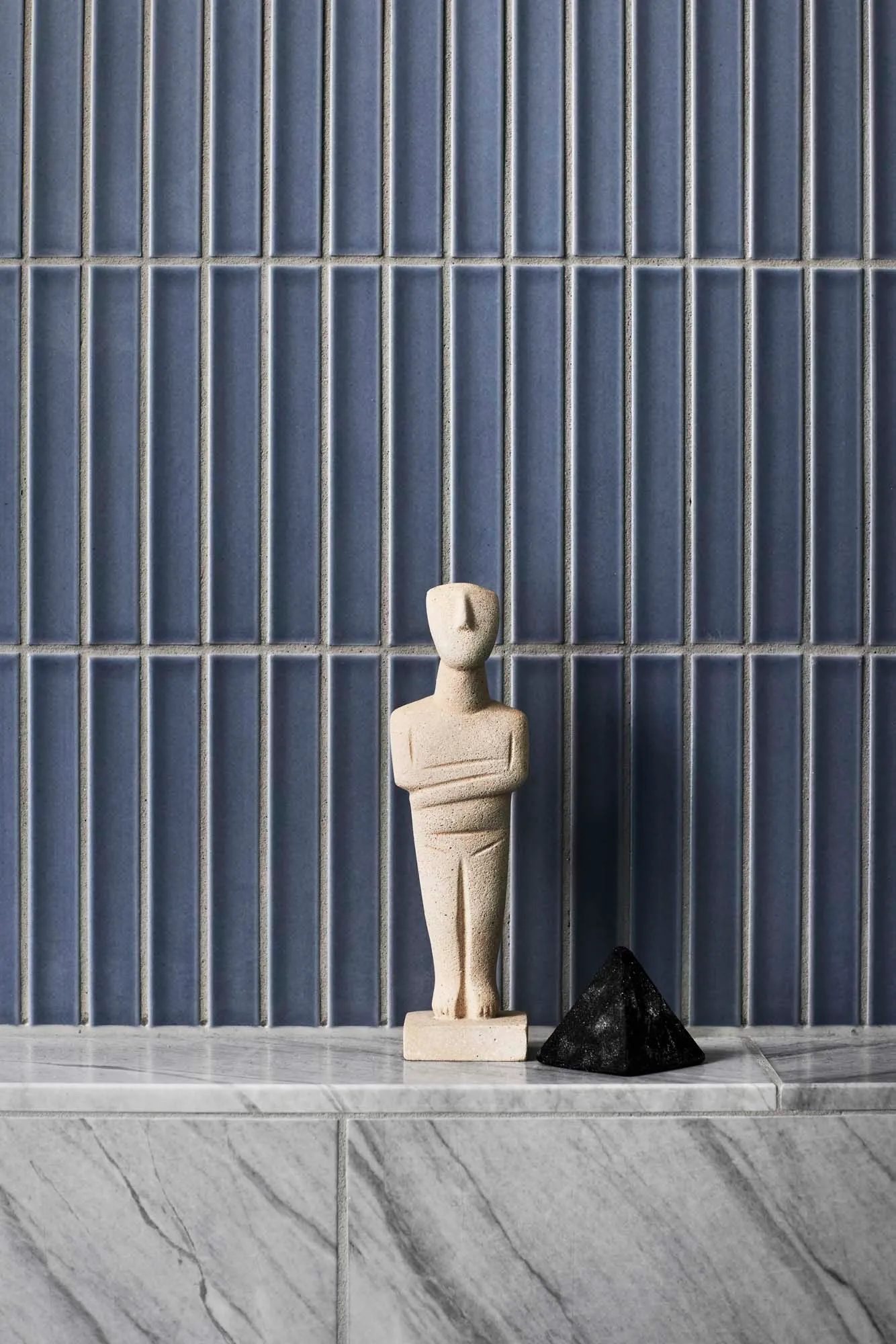 A minimalist interior design featuring marble and concrete materials.