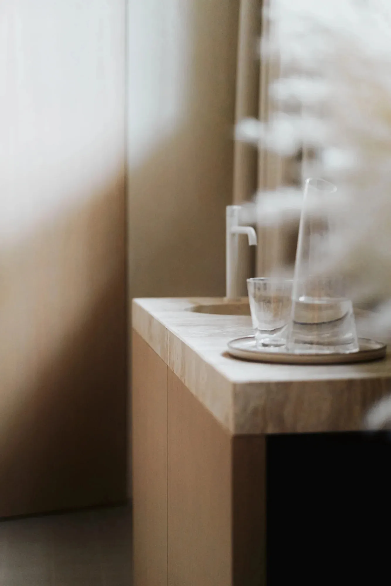 A minimalist bathroom featuring a marble countertop and sink.