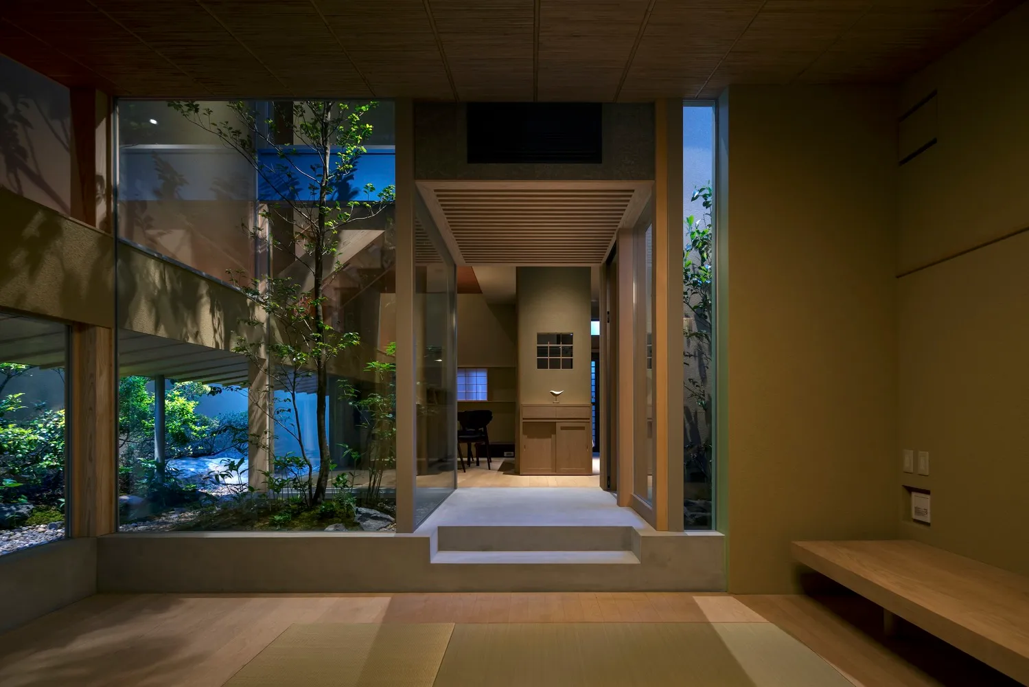A modern Japanese-style residence featuring glass walls and wooden elements.