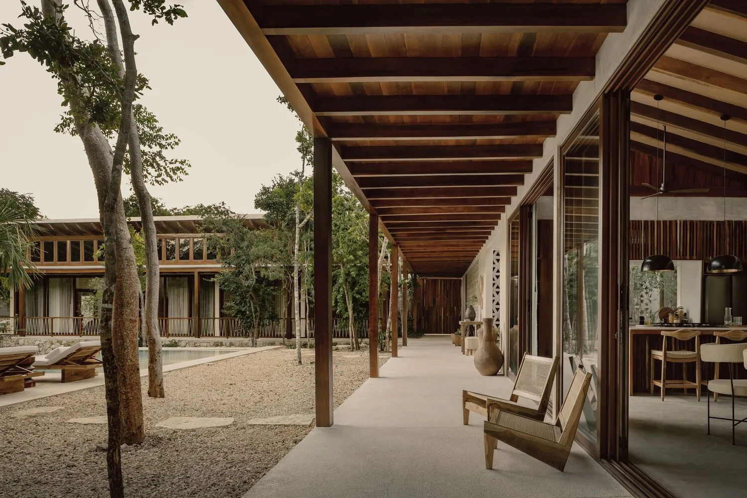 Modern residential patio with wood accents and a covered walkway.