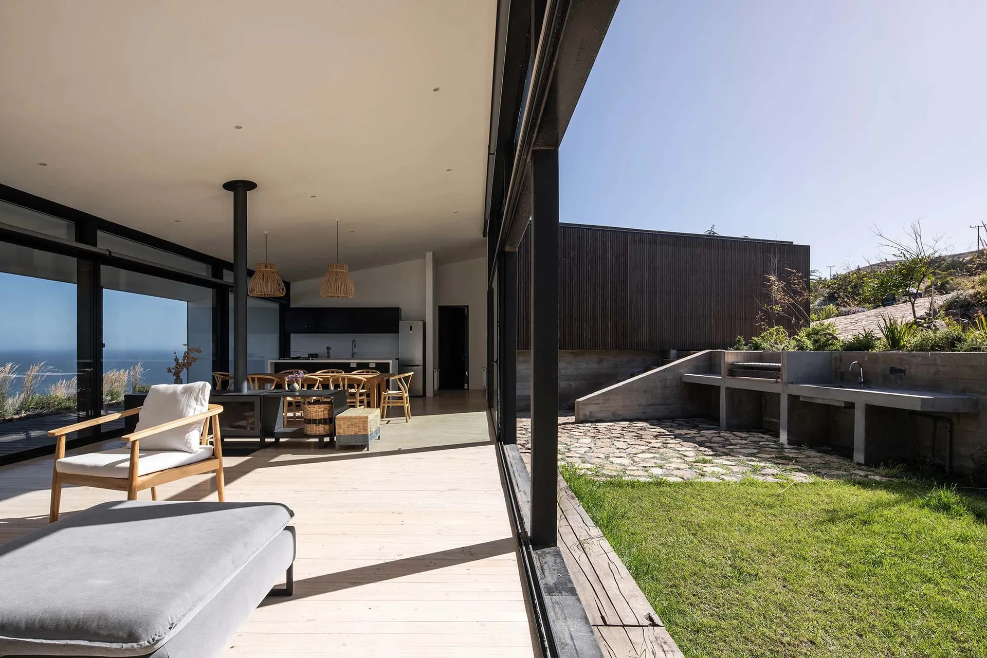 A modern residential interior featuring wood, concrete, and glass materials.