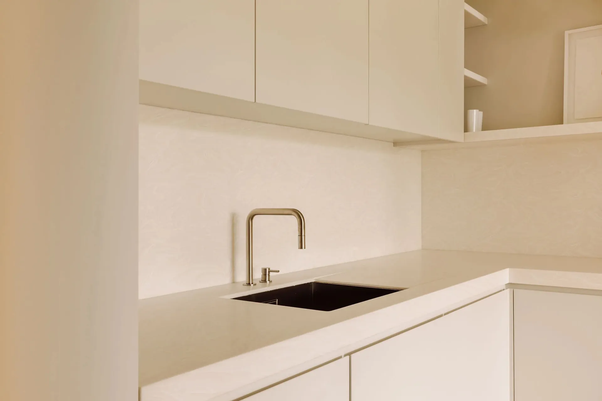 A modern kitchen featuring a sleek stone countertop and minimalist design.
