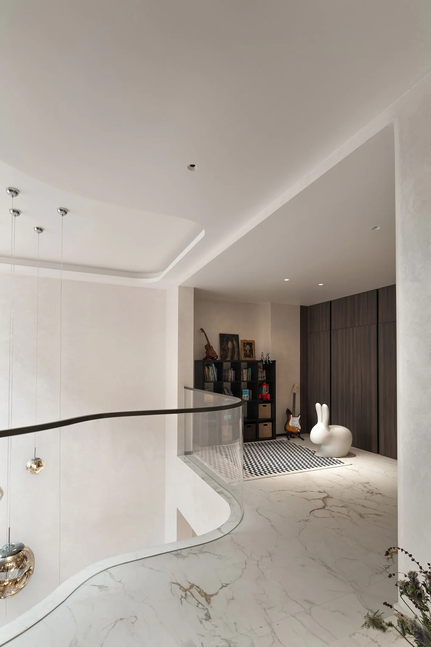 A modern, minimalist entrance hallway with marble flooring, white walls, and a glass railing. Features include a white rabbit