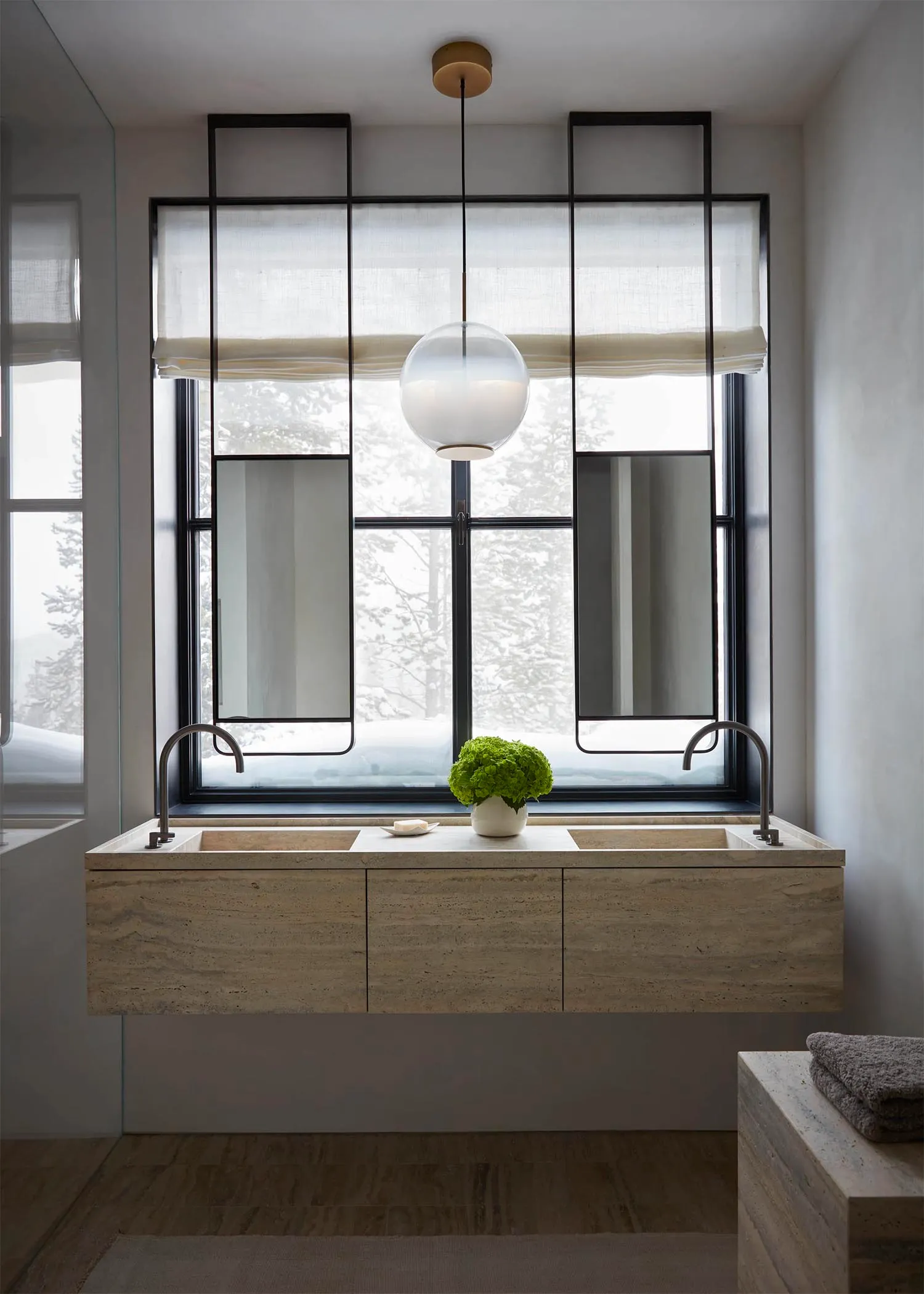 Modern minimalist bathroom with marble sink and large window.