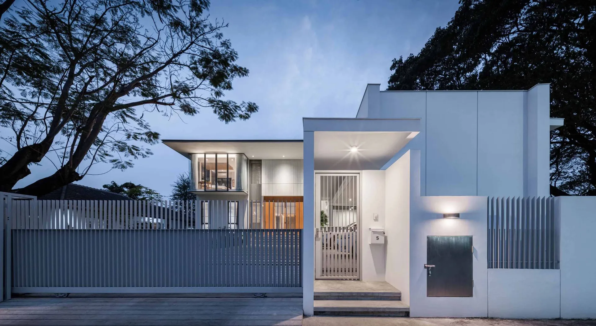 Modern residential building with white painted exterior and sleek architectural design.
