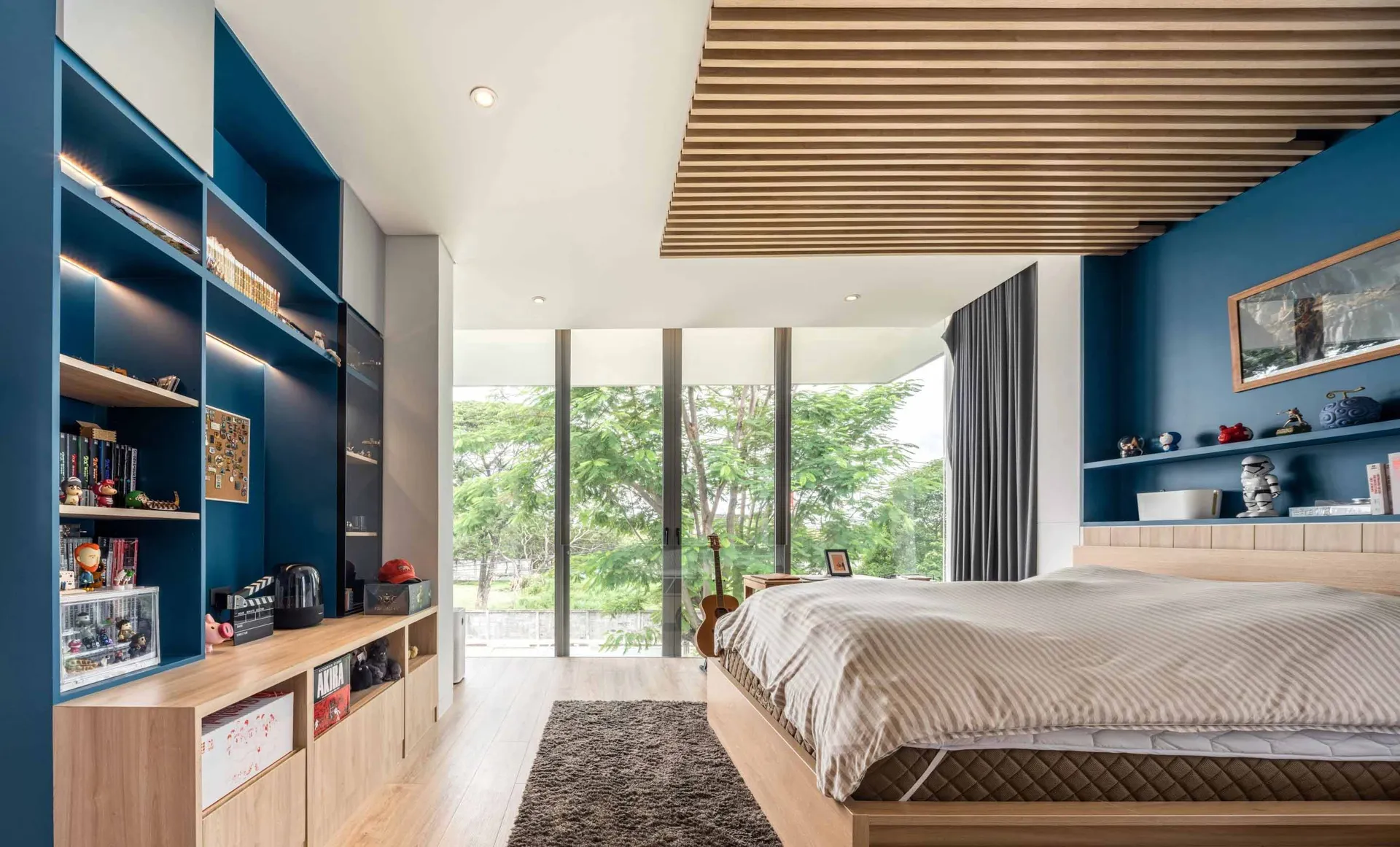 A modern bedroom featuring wood, blue, and grey colors.