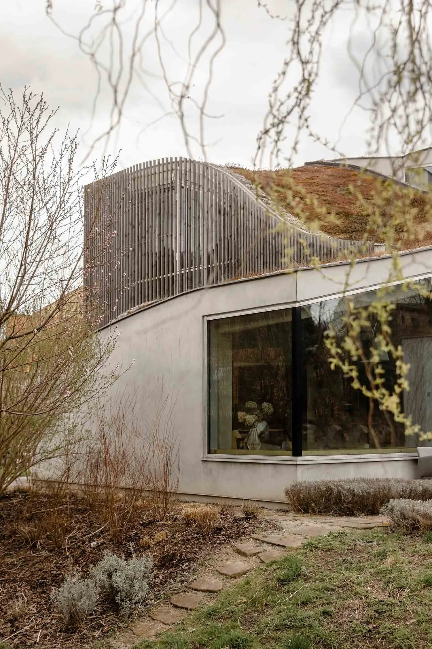 Modern house with concrete facade and large windows.