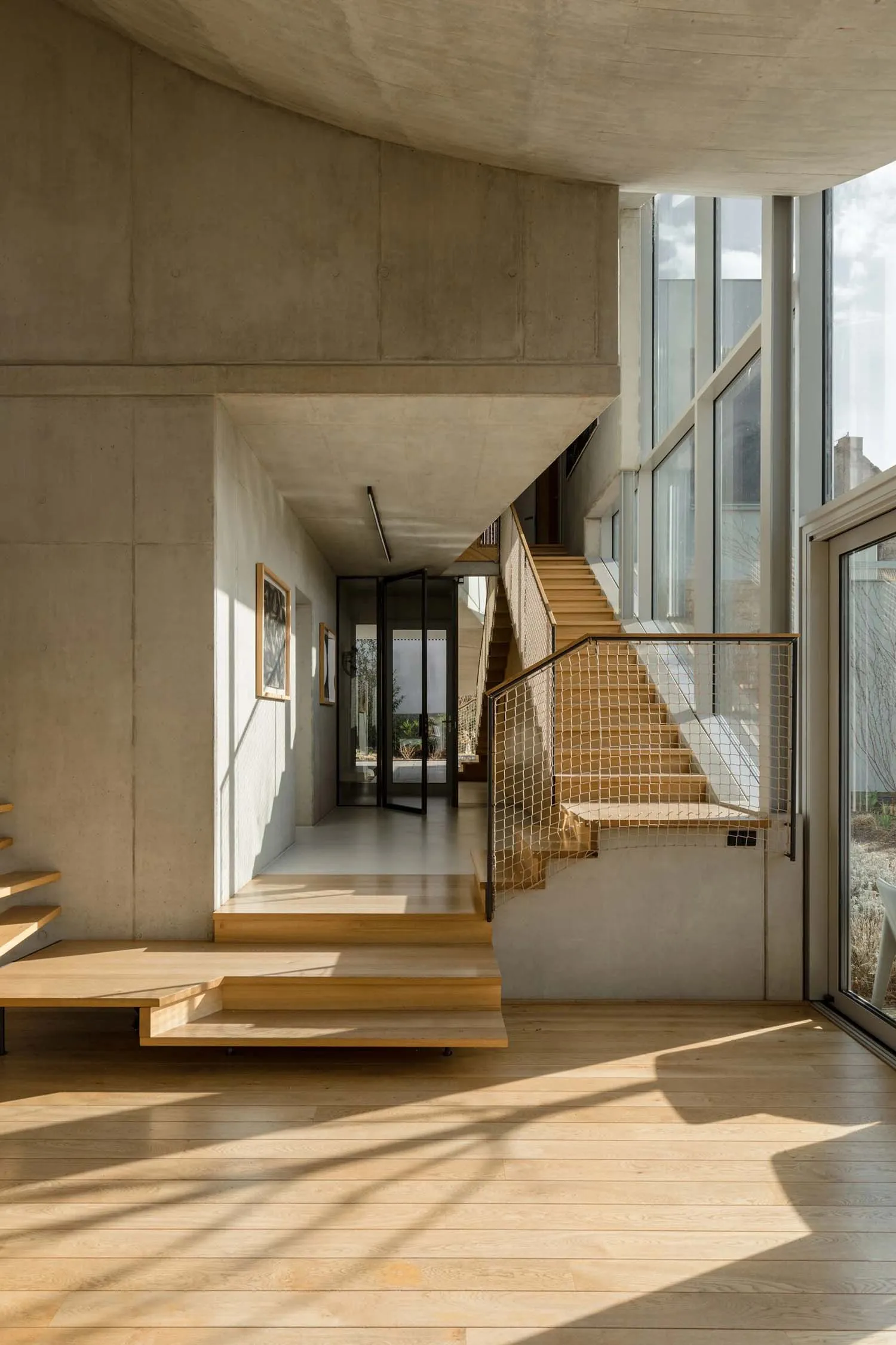 Modern interior design featuring concrete and wooden elements.