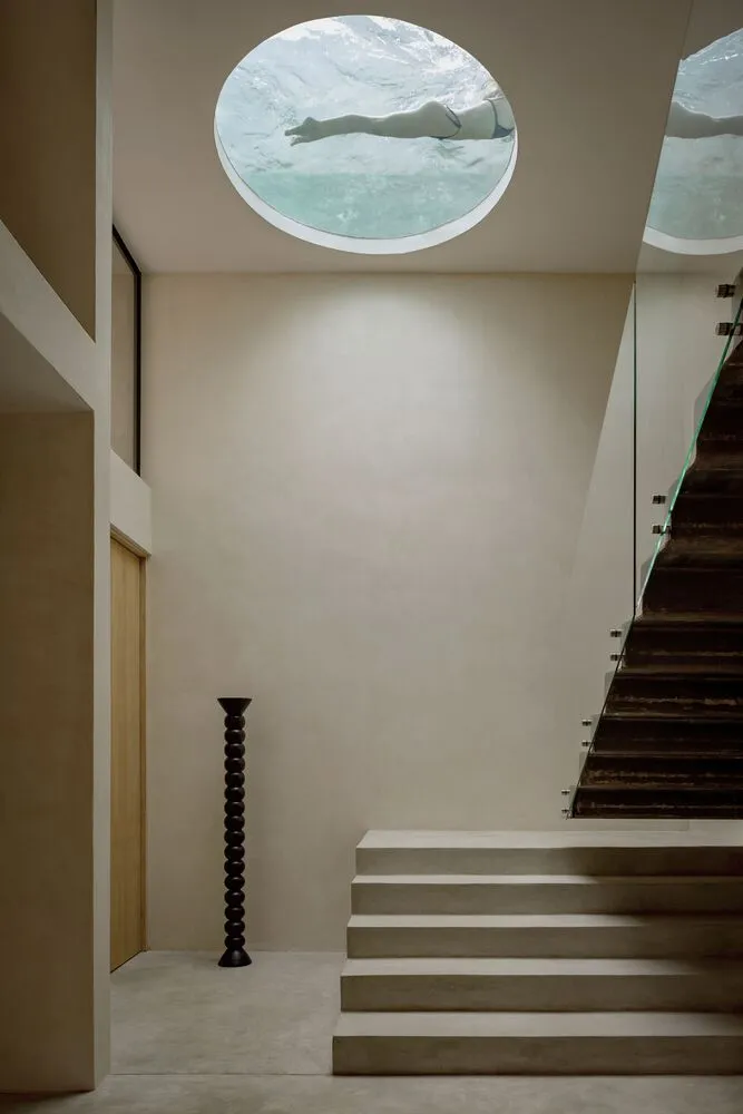 Modern interior with concrete stairs and glass wall