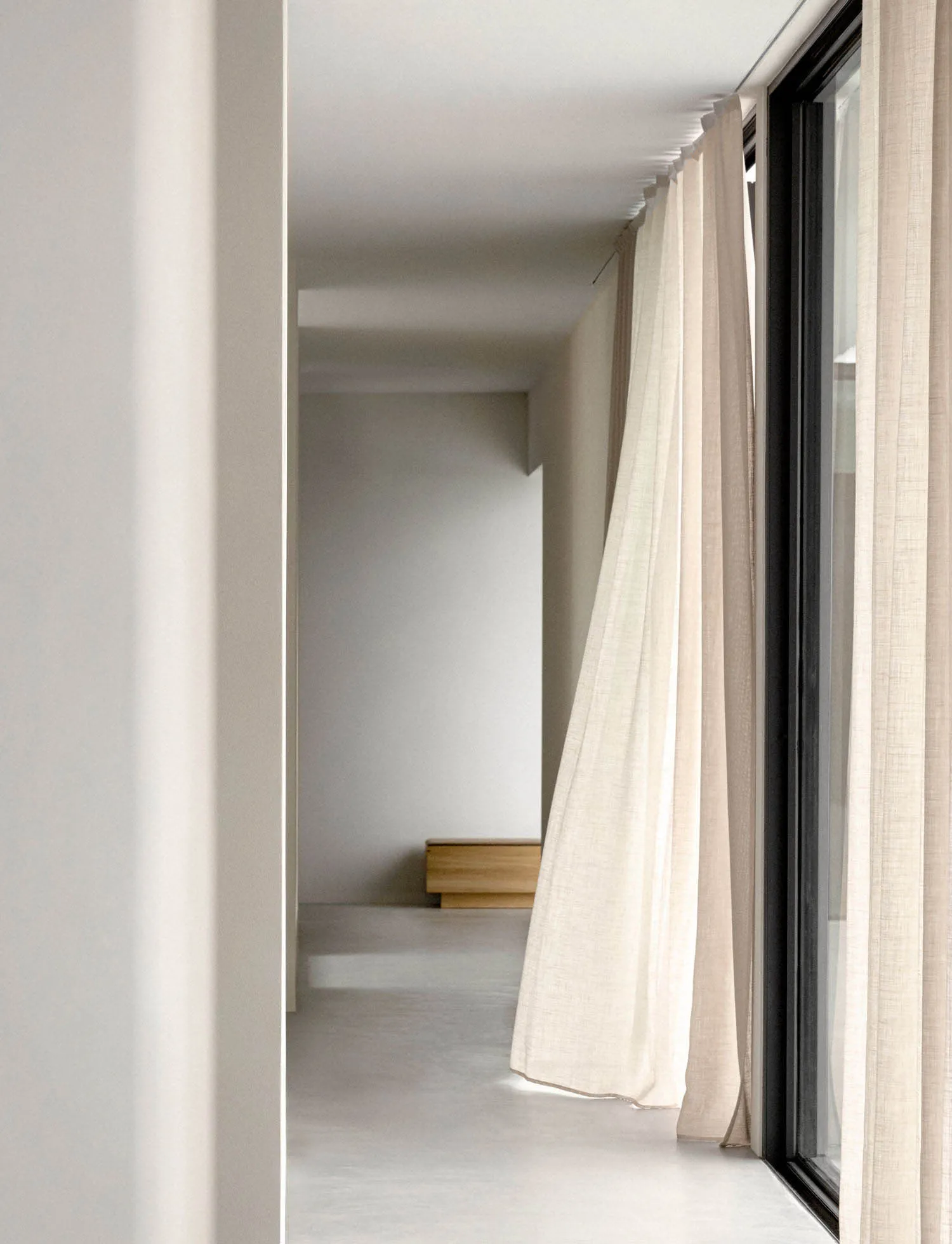 Lighting design in a modern room with minimalistic decor and fabric curtains.
