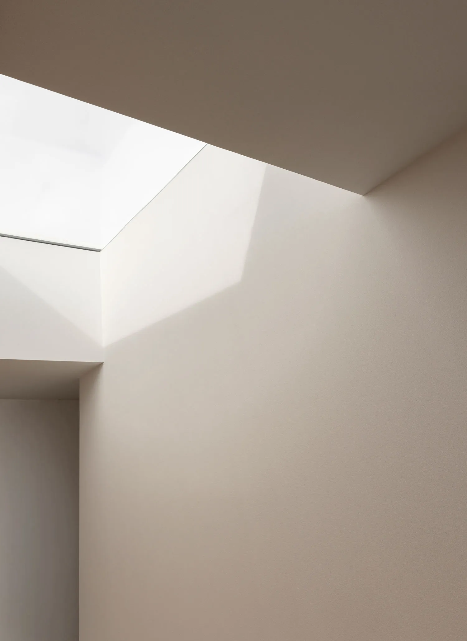 Minimalist interior design featuring natural light through a large window.