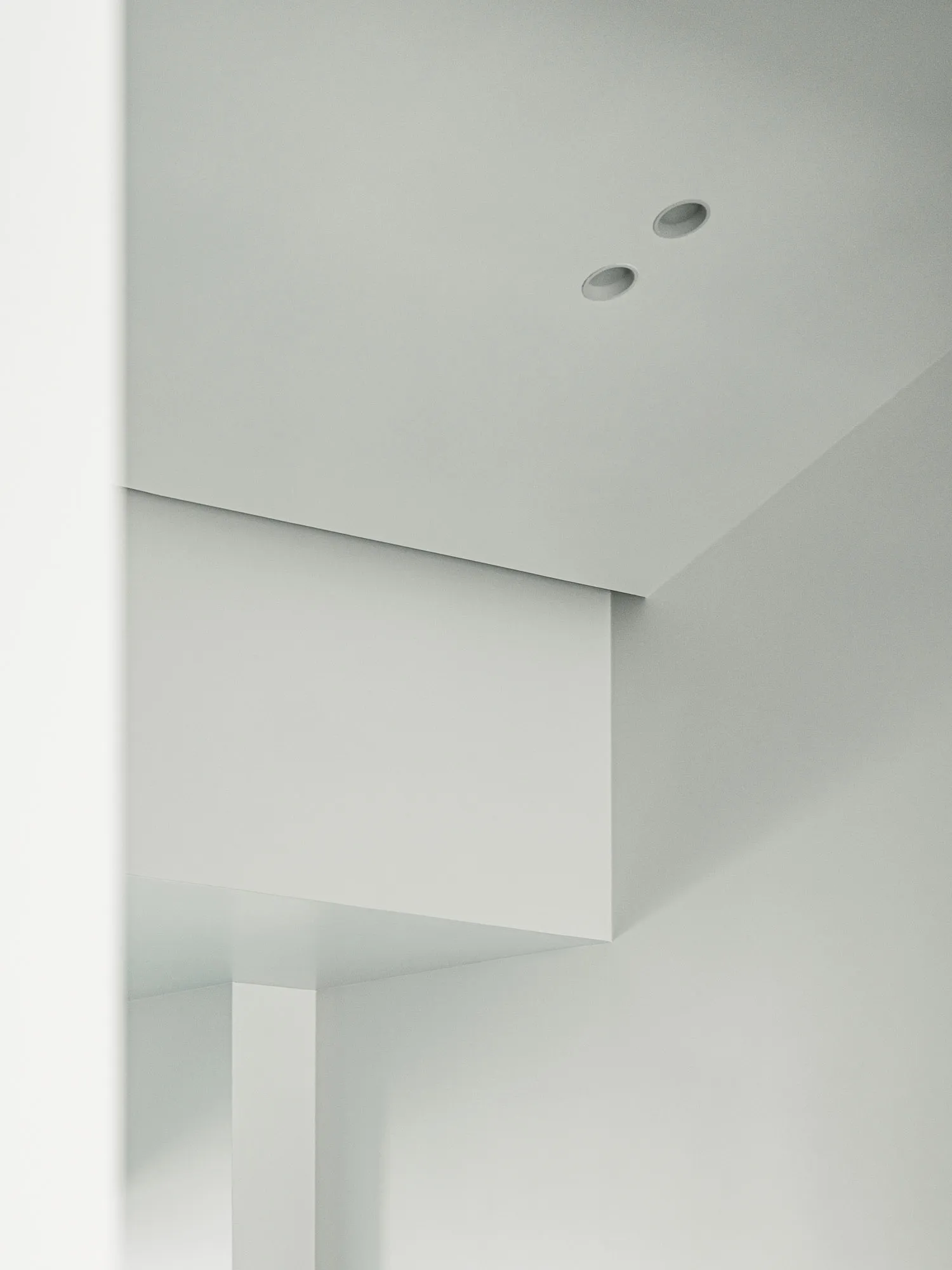 A minimalist interior design with white walls and a clean, uncluttered space.