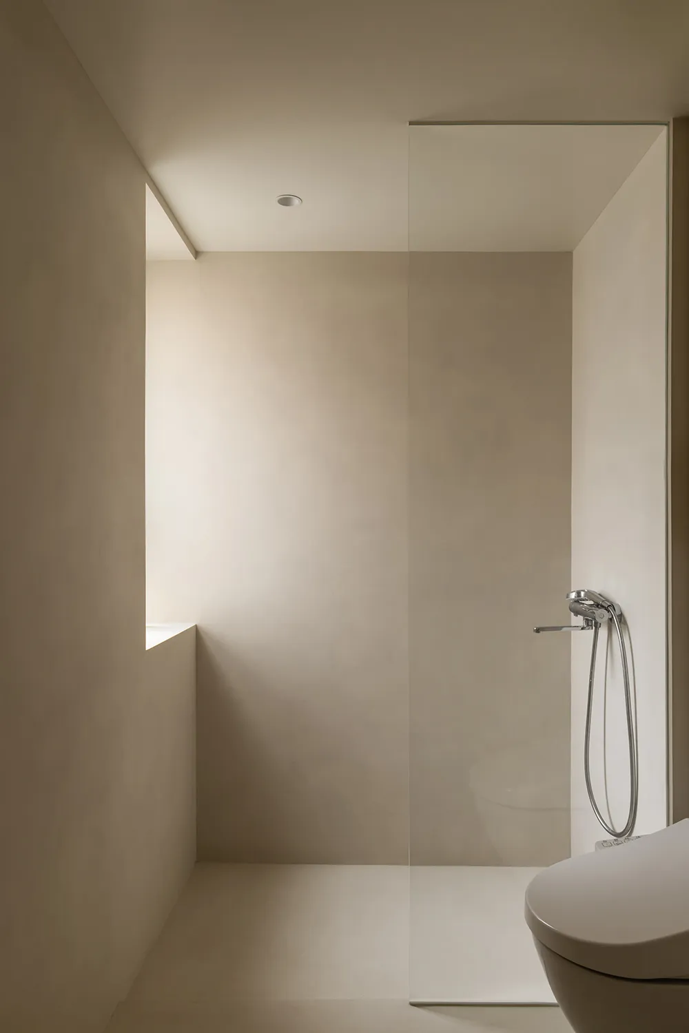 Modern, minimalist bathroom featuring transparent glass walls.