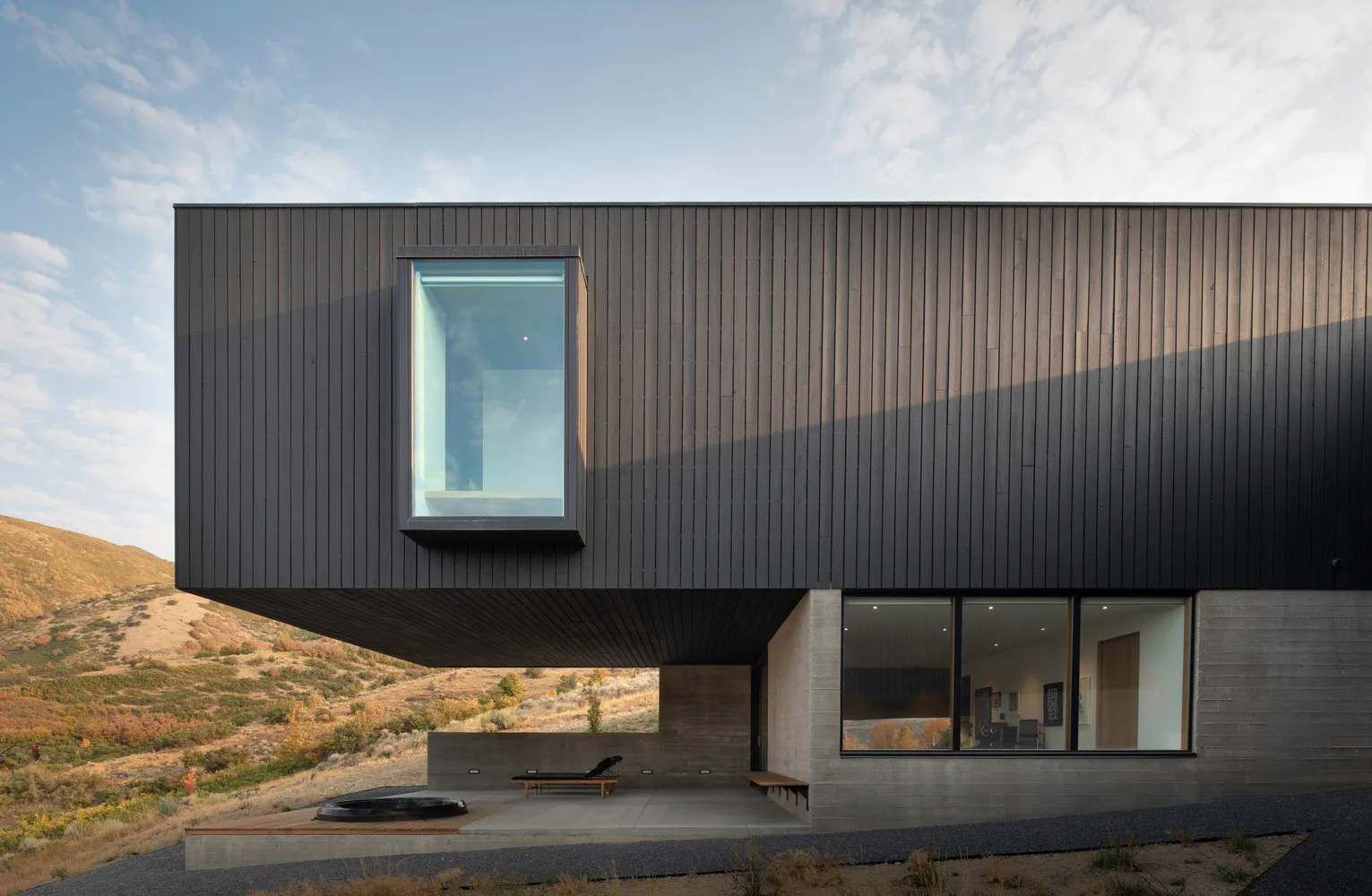 A modern building with a metallic exterior in a natural setting.